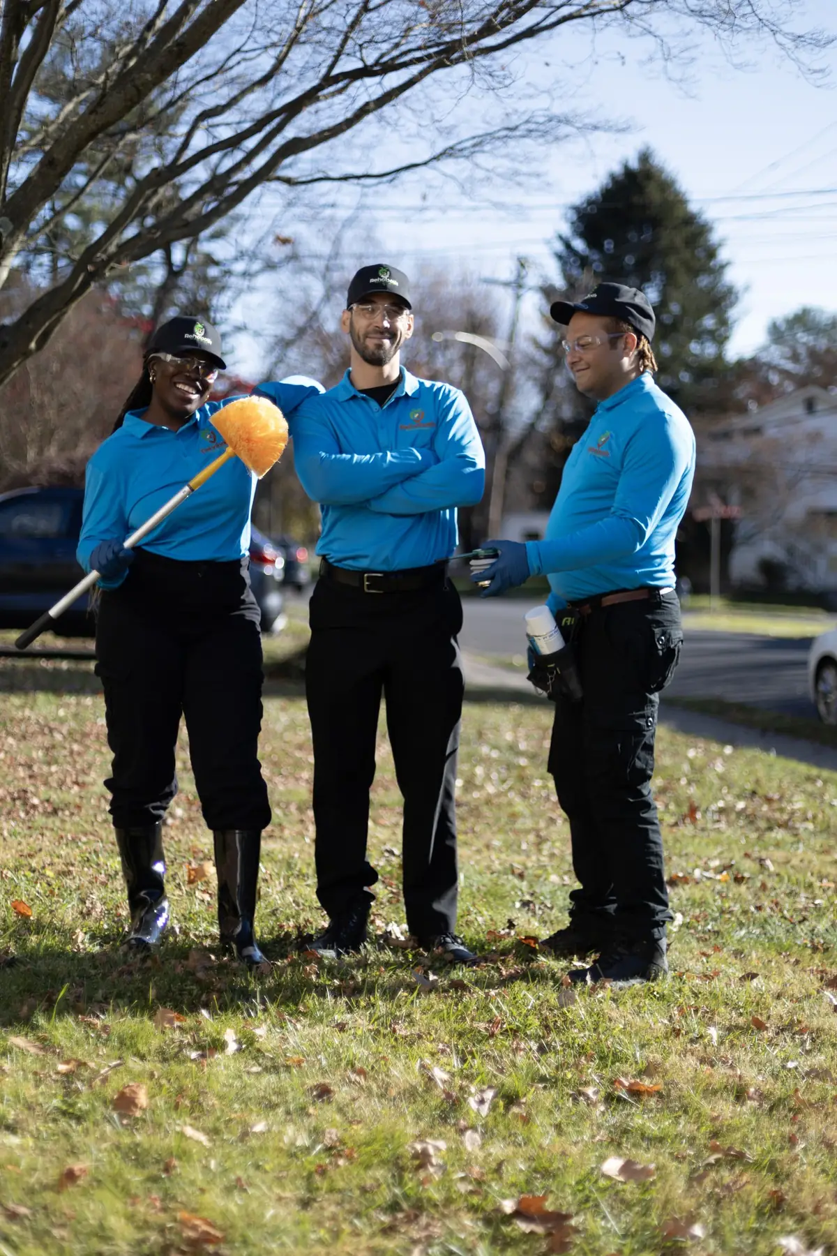 Three Rehoboth technicians standing on a front lawn