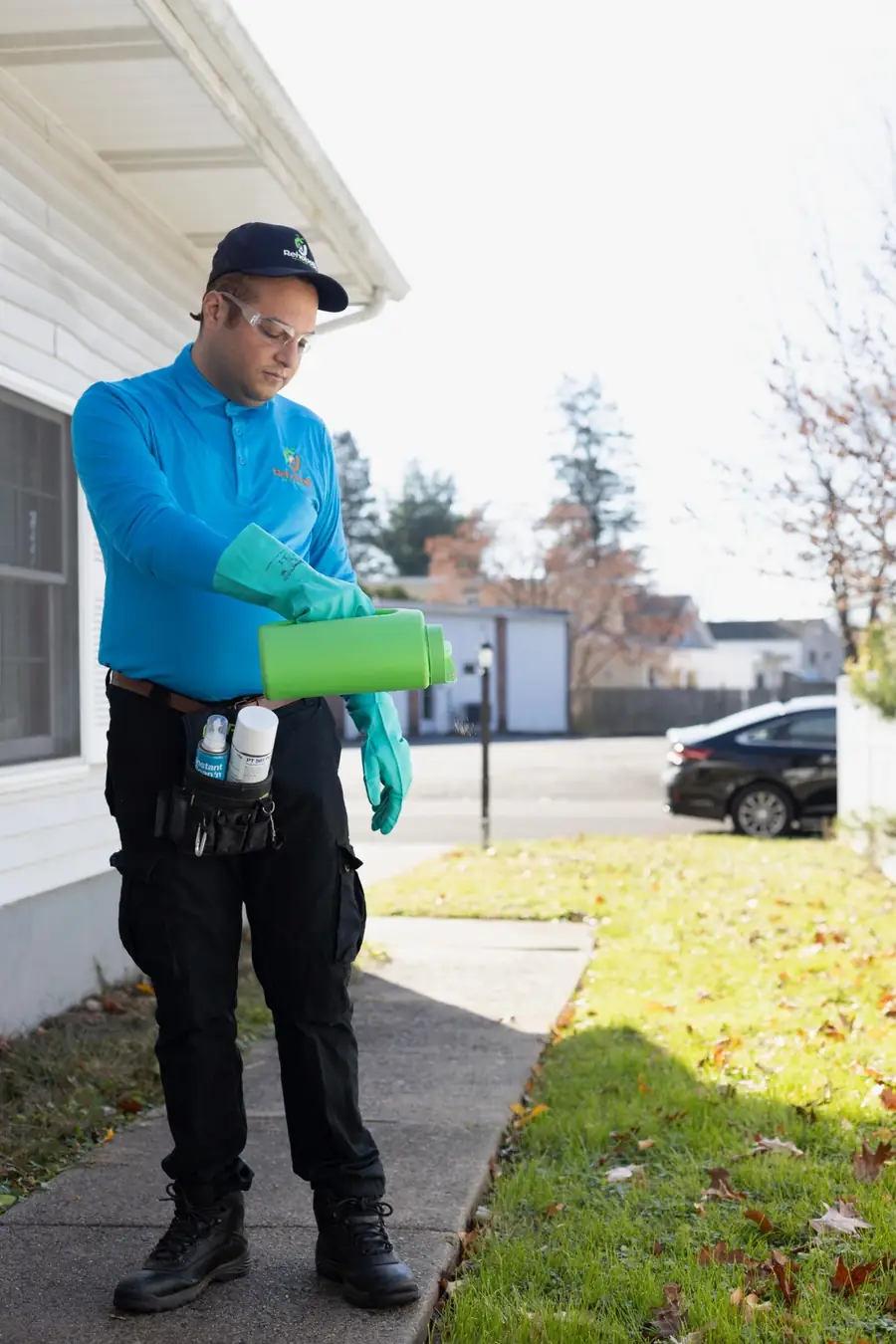 Technician spreading granular treatment along a lawn edge