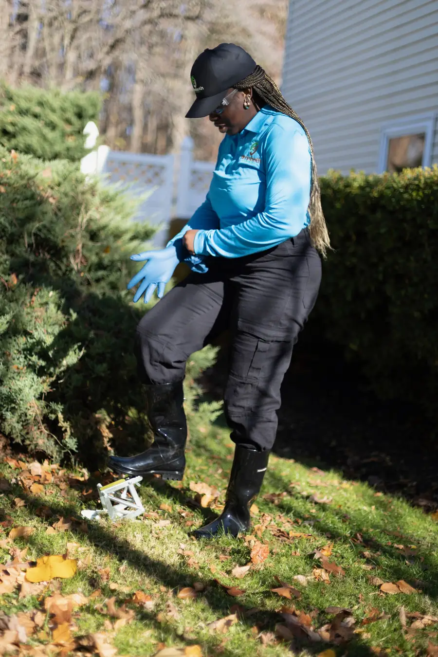 Technician setting a mole trap in a lawn