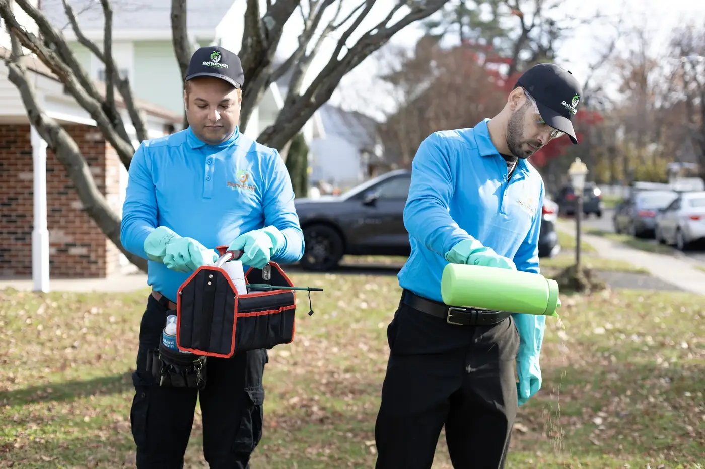Two Rehoboth technicians preparing products on a lawn